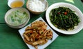 Top view simple vegan meal for daily family menu, fried tofu cook with sauce, water spinach, vegetables soup, rice