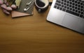 Top view simple workplace with laptop computer, coffee cup and notebook on wooden table. Copy space