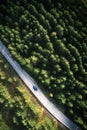 Top view of single blue car driving through forest in Zlatibor, Serbia