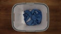 TOP VIEW: Single cloth in a laundry basket on a floor