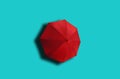 Top view, Single red umbrella isolated on cyan background, stock photo, invesment, business, summer concept Royalty Free Stock Photo