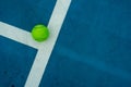 Single tennis ball on blue tennis court Royalty Free Stock Photo