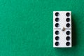 Top view of six double dominoes on green mat horizontally Royalty Free Stock Photo