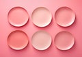Top view on six empty pink plates of different tone on pink table