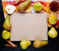 Top view of a sketchbook and fresh ripe pears arranged around with a glass of pear juice on black background Royalty Free Stock Photo