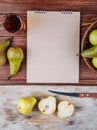 Top view of a sketchbook and fresh ripe pears with a glass of pear juice on wooden background Royalty Free Stock Photo