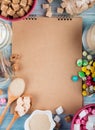 Top view of a sketchbook with various types of sugar and candies in bowls and glass jars arranged around on rustic background Royalty Free Stock Photo