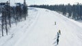 Top view of skiers and snowboarders riding on mountain. Footage. Ski resort with active rest on skis and snowboard in