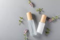 Top view of skincare bottles on a surface with lavender flower