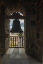 Top view through the slatted window from the high tower of the church. Outside the window are tiled roofs of historic buildings. Royalty Free Stock Photo