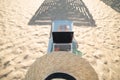 Top view of slender young caucasian woman in hat works on his laptop resting on sandy beach on a sunny day. Slender legs Royalty Free Stock Photo