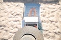 Top view of slender young caucasian woman in hat works on his laptop resting on sandy beach on a sunny day. Slender legs Royalty Free Stock Photo