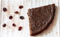 Top view of slice of delicious dark chocolate cake with cranberry and chocolate shavings, on white background.Flat lay. Royalty Free Stock Photo