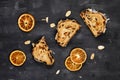 Top view of slice of German Stollen cake, a fruit bread with nuts, spices, and dried fruits with powdered sugar