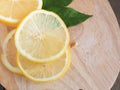 Top view slice lemon fruit with leaves on cutting board. Royalty Free Stock Photo