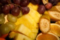 top view on sliced bananas, oranges, pineapples, and grapes Royalty Free Stock Photo