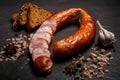 top view on sliced circle of dry-cured ham sausage with rye bread Royalty Free Stock Photo