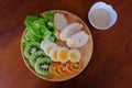 Top view of Sliced egg salad serve with vegetable, kiwi, tomato, crispy bread and separated Japanese sesame dressing Royalty Free Stock Photo