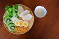 Top view of Sliced egg salad serve with vegetable, kiwi, tomato, crispy bread and separated sesame dressing Royalty Free Stock Photo