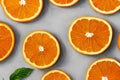 Top view of sliced, juicy orange fruit on grey background