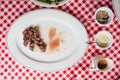 Top view of Sliced medium rare charcoal grilled wagyu Ribeye steak in white plate on red and white pattern tablecloth. Royalty Free Stock Photo