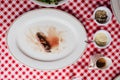 Top view of Sliced medium rare charcoal grilled wagyu Ribeye steak in white plate on red and white pattern tablecloth. Royalty Free Stock Photo