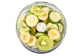 Top view, slices of banana, cucumber, kiwi, apple, spinach, lime in a blender