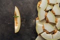 top view of slices of sweet ripe melon on black grunge