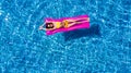 Top view of slim young woman in bikini on the air mattress in the big swimming pool. Enjoying sunmtan. Vacation concept Royalty Free Stock Photo