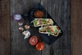 Top view of slow cooked short ribs on tortillas with a spring onion tomato salsa