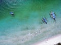 Top view small beach with vacationing people, banca boats and pa