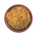 Top view of a small bowl filled with Cajun blackened seasoning isolated on a white background