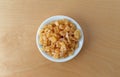 Top view of a small bowl filled with dried diced peaches Royalty Free Stock Photo