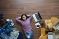 Top view small business owner woman lying on wooden floor