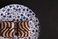 Top view of small chocolate biscuits on a plate on a black surface Royalty Free Stock Photo
