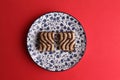 Top view of small chocolate biscuits on a plate on a red surface Royalty Free Stock Photo