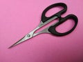 Close Scissors isolated on pink background