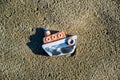 Top view of small cute miniature ceramic boat on sandy beach Royalty Free Stock Photo