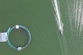 Top view of a small fishing boat passing by a circular fish pen. At Kakiputan Channel in Anda, Pangasinan Royalty Free Stock Photo