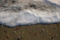 A top view of a small wave with foam on the sand Royalty Free Stock Photo
