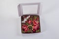 Top view on small white gift box with soft cotton scarf with red rose ornament Royalty Free Stock Photo