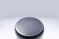 Top view of small wireless speaker showing black metal grille Royalty Free Stock Photo