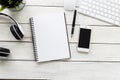 Top view smart phone with computer and empty notebook on wooden table Royalty Free Stock Photo