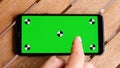 Top view smart phone place on table wood with green screen and markers