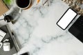 Top view smart phone, wireless earphone, coffee cup and notebook on marble table Royalty Free Stock Photo