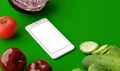 Top view of smartphone with blank screen and fresh raw vegetables on wooden table. 3D illustration