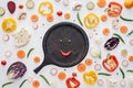 top view of smiley face from green peas and red pepper on round wooden board Royalty Free Stock Photo