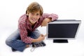 Top view of smiling child pointing at tv