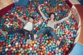 Top view. Smiling mom and son in pool with balls