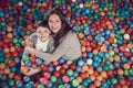 Top view. Smiling mom and son in pool with balls